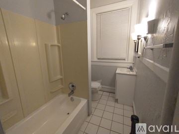 Baltimore apartment for rent - A kitchen with a stove top oven and a refrigerator.