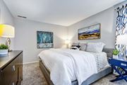Silver Spring apartment for rent - A bedroom with a bed, nightstand, and two lamps.