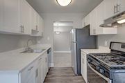 Silver Spring apartment for rent - A kitchen with white cabinets and a stainless steel refrigerator.