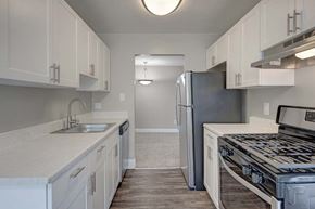 Silver Spring apartment for rent - A kitchen with white cabinets and a stainless steel refrigerator.