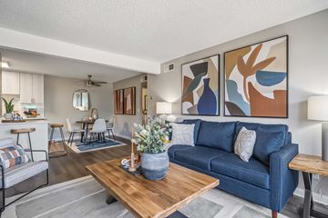 Phoenix apartment for rent - A living room with a blue couch and a wooden coffee table.