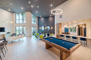 Venice apartment for rent - A pool table is in the middle of a room with a white couch and chairs.