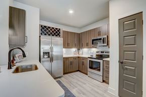 Venice apartment for rent - A modern kitchen with wooden cabinets and stainless steel appliances.