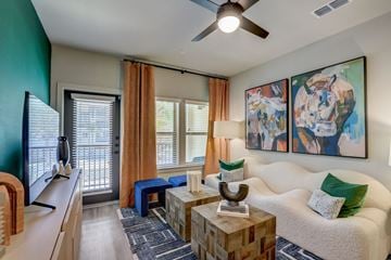 Venice apartment for rent - A living room with a white couch, a wooden coffee table, and a painting on the wall.