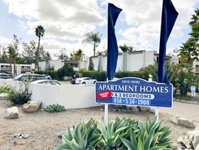 San Diego apartment for rent - A blue sign for apartment homes with a red and white striped flag on top.