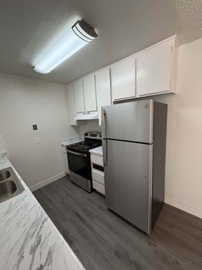 San Diego apartment for rent - A kitchen with a refrigerator, oven, and sink.