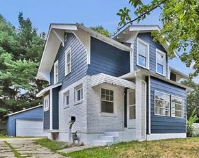 Akron house for rent - A blue house with white trim and a grey roof.