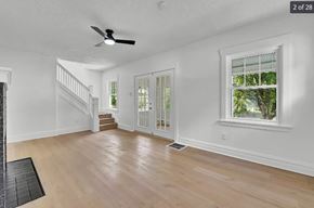Akron house for rent - A spacious room with a staircase and a window.