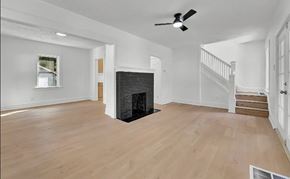 Akron house for rent - A living room with a fireplace and a staircase.