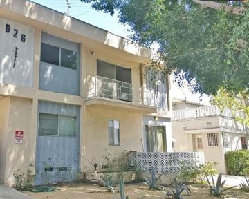Los Angeles apartment for rent - A two-story building with a balcony and a blue door.