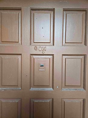 Brownsville apartment for rent - A brown door with a silver handle and a lock.