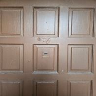 Brownsville apartment for rent - A white door with a silver handle and a silver lock.