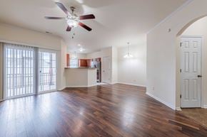 Jacksonville house for rent - A room with a ceiling fan and wooden floors.