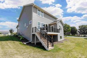 Hastings house for rent - A house with a grey exterior and a black railing on the balcony.
