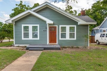 Dallas house for rent - A small house with a brown door and a grey roof.