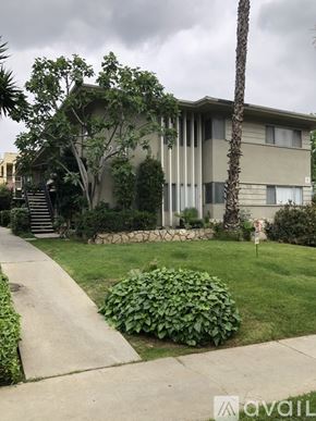 Glendale apartment for rent - A house with a green lawn and a palm tree in front.
