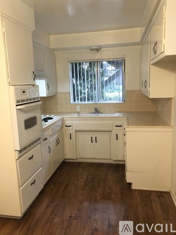 Glendale apartment for rent - A kitchen with white appliances and cabinets.