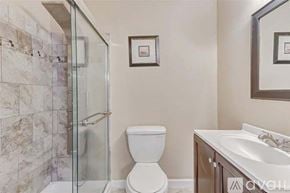 Seabrook house for rent - A bathroom with a toilet, sink, and shower.