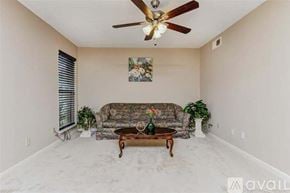 Seabrook house for rent - A living room with a couch, a coffee table, and a ceiling fan.