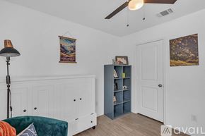 New Braunfels house for rent - A bedroom with a large bed and a ceiling fan.