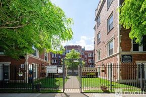 Chicago apartment for rent - A gated entrance to a brick building with a sign that reads "Annenberg.".