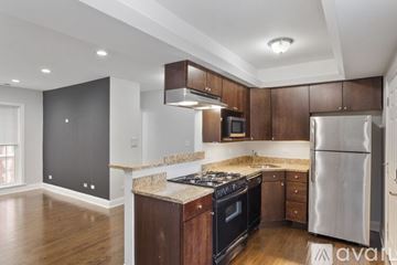 Chicago apartment for rent - A kitchen with wooden cabinets and a stainless steel refrigerator.