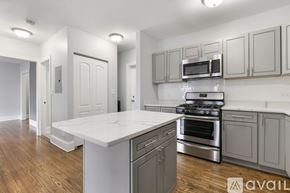 Chicago apartment for rent - A kitchen with a white countertop and stainless steel appliances.