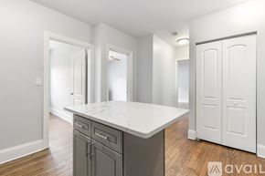 Chicago apartment for rent - A kitchen with a marble countertop and wooden flooring.