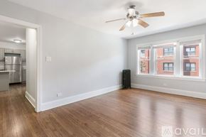 Chicago apartment for rent - A room with a ceiling fan and wooden flooring.