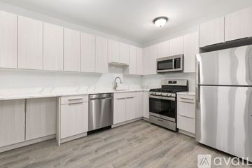 Chicago apartment for rent - A kitchen with white cabinets and stainless steel appliances.
