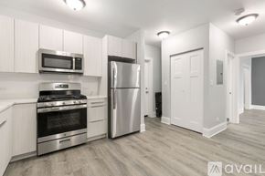 Chicago apartment for rent - A kitchen with a stove, microwave, and refrigerator.