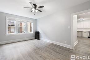 Chicago apartment for rent - A room with a ceiling fan and a window with blinds.