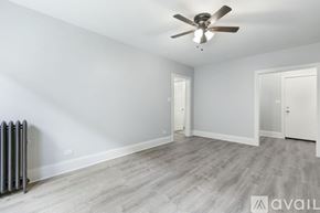 Chicago apartment for rent - A room with a ceiling fan and a radiator on the floor.