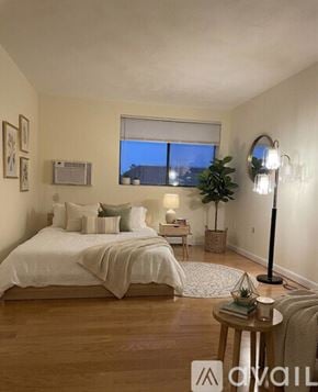 Winthrop apartment for rent - A hallway with a white door and wooden floor.