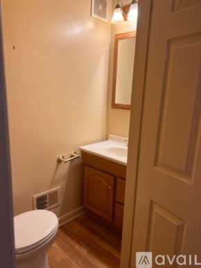 Pittsburgh apartment for rent - A bathroom with a toilet, sink and mirror.