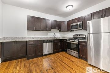 Chicago apartment for rent - A kitchen with wooden floors and stainless steel appliances.