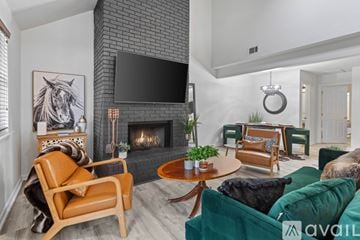 Tallahassee townhouse for rent - A living room with a fireplace and a television mounted above it.