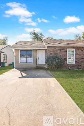 Belton house for rent - A room with wooden floors and a kitchen area in the background.