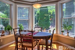 Asheville house for rent - A dining room with a table and chairs and a window.