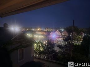 Scranton apartment for rent - A view from a window at night showing a cityscape with buildings and lights.