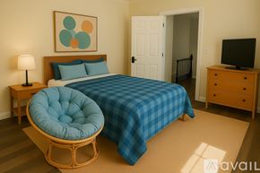 Scranton apartment for rent - A bedroom with a bed, a chair, a nightstand, and a television.