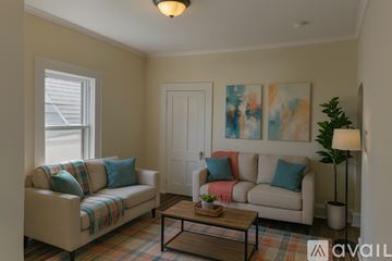 Scranton apartment for rent - A living room with a couch, a coffee table, and a painting on the wall.