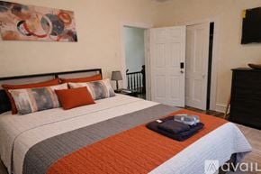 Scranton apartment for rent - A bedroom with a large bed and a painting on the wall.