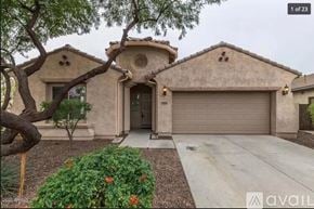 Phoenix house for rent - A house with a beige exterior and a garage door is for sale.