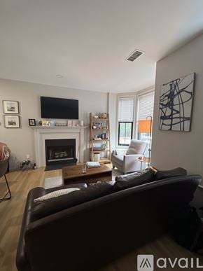 Boston apartment for rent - A living room with a fireplace and a couch.
