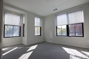 Boston apartment for rent - A room with two windows and a carpeted floor.