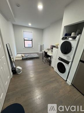 Boston apartment for rent - A small room with a washing machine and dryer built into the cabinetry.