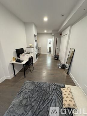 Boston apartment for rent - A room with a bed, desk, and chair.