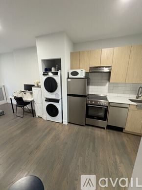 Boston apartment for rent - A modern kitchen with a washing machine and dryer built into the cabinetry.