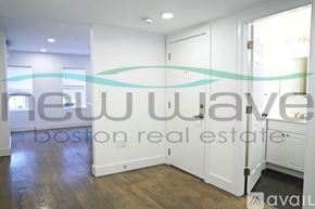 Boston apartment for rent - A room with a wooden floor and white walls, with a sign that reads "New Wave Boston real estate available".